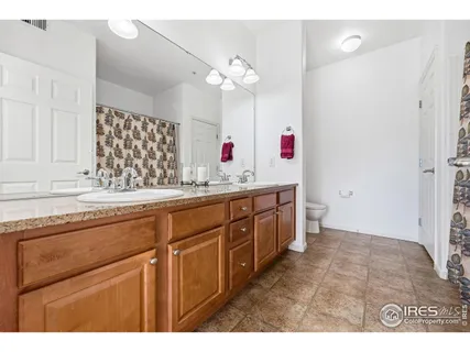a bathroom with a sink a vanity and a large mirror