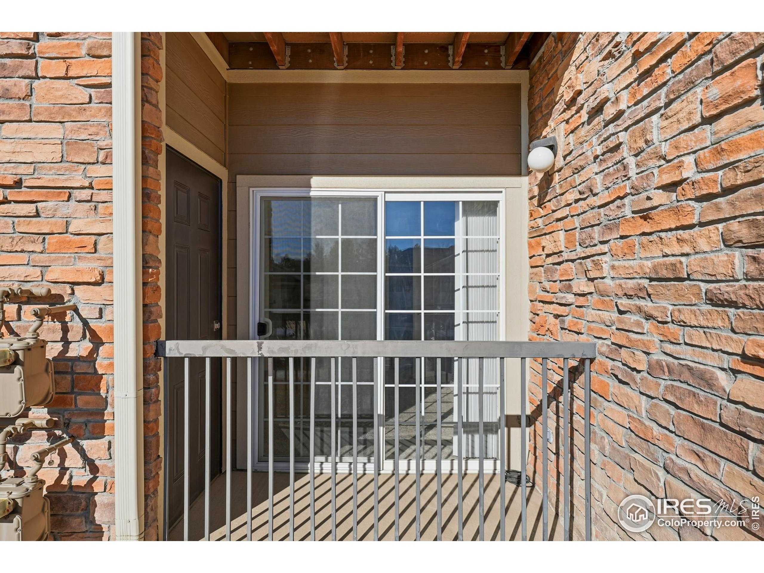 1425 Blue Sky Circle, Unit 15105 Erie, CO 80516 - Photo 27 of 45 a view of a brick house with a large window