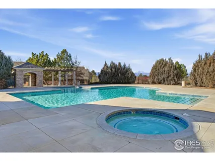 a view of a swimming pool with an outdoor space and seating area