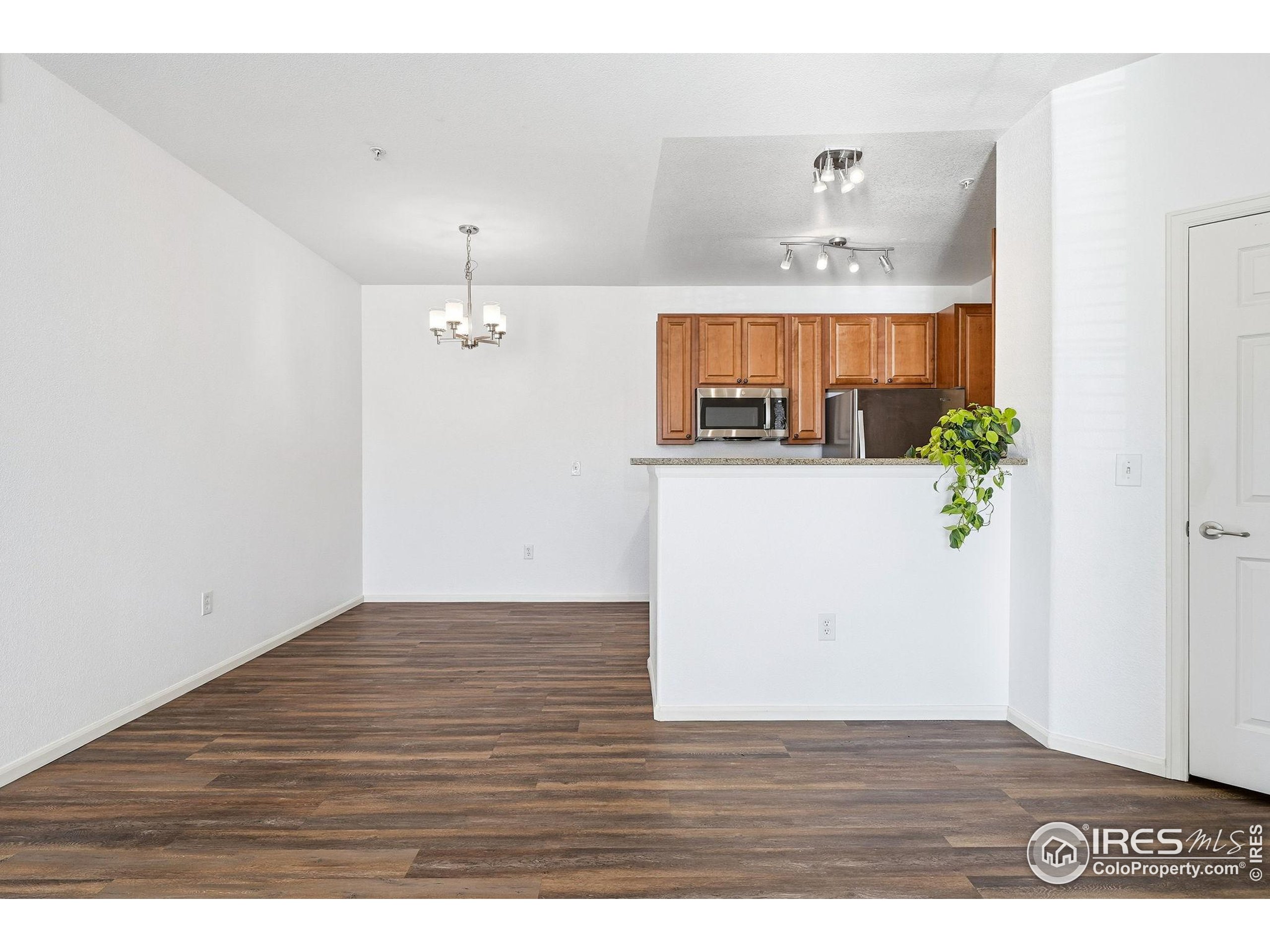 1425 Blue Sky Circle, Unit 15105 Erie, CO 80516 - Photo 7 of 45 a view of a room with wooden floor