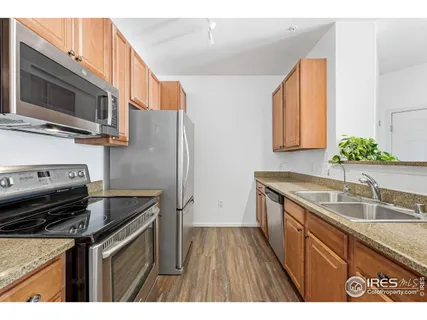 a kitchen that has a sink and a stove top oven