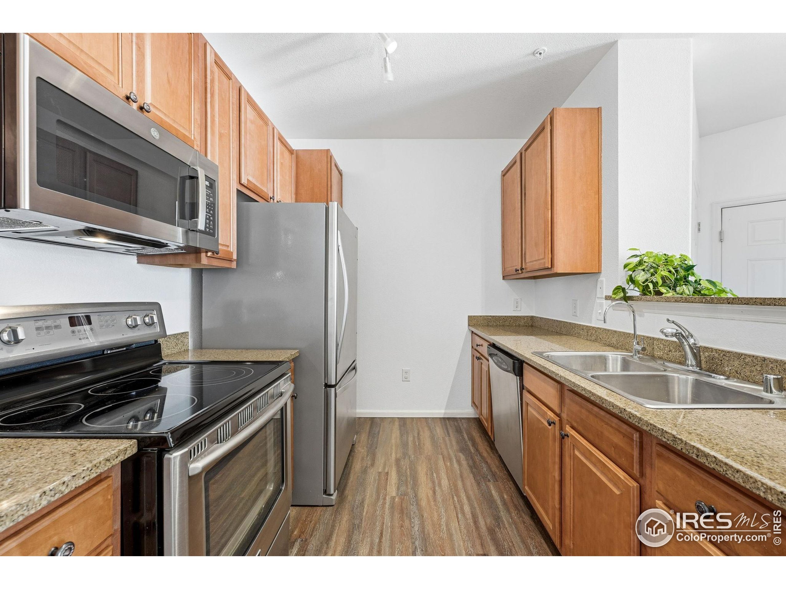 1425 Blue Sky Circle, Unit 15105 Erie, CO 80516 - Photo 10 of 45 a kitchen that has a sink and a stove top oven