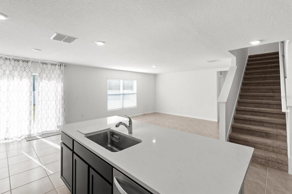 13691 Southwest 69th Terrace Ocala, FL 34473 - Photo 13 of 44 a kitchen that has a sink a stove and a window