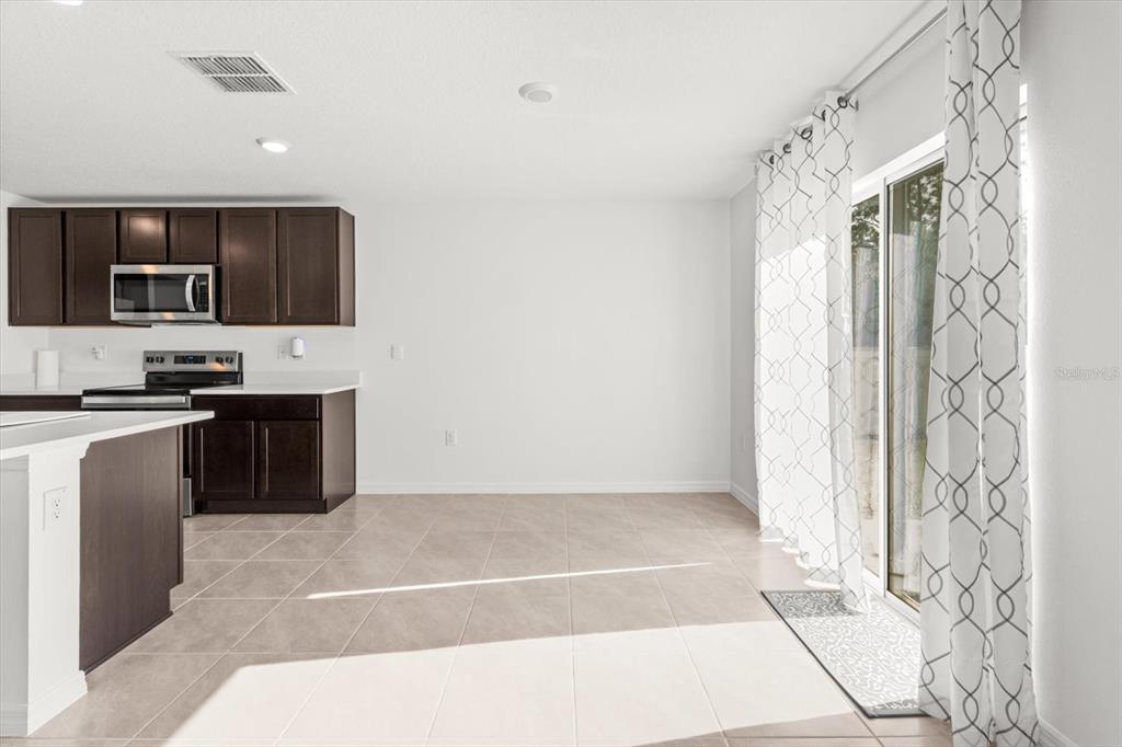13691 Southwest 69th Terrace Ocala, FL 34473 - Photo 14 of 44 a kitchen with a sink a stove and cabinets