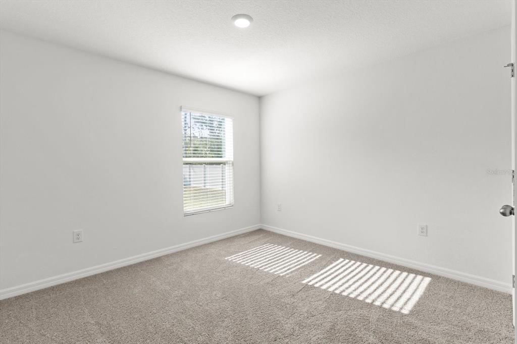 13691 Southwest 69th Terrace Ocala, FL 34473 - Photo 17 of 44 an empty room with a window