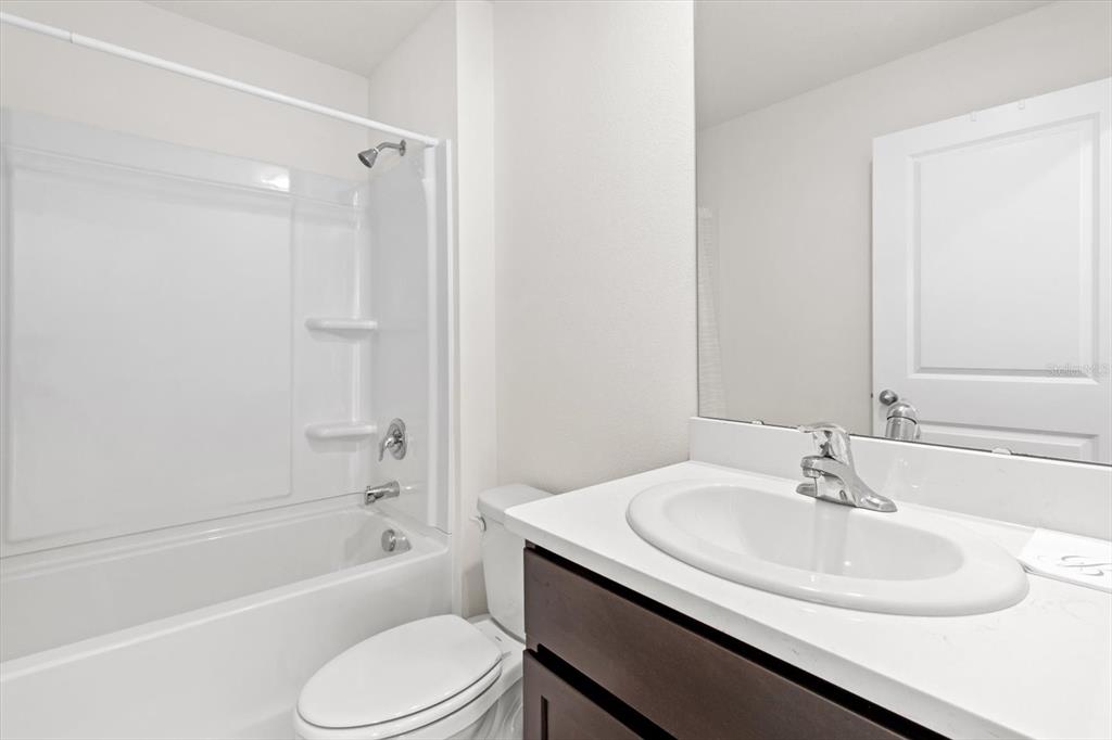 13691 Southwest 69th Terrace Ocala, FL 34473 - Photo 19 of 44 a bathroom with a sink toilet and a bathtub
