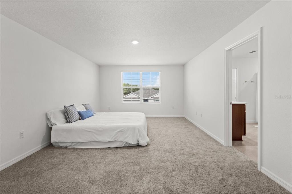 13691 Southwest 69th Terrace Ocala, FL 34473 - Photo 21 of 44 a living room with a bed furniture and a window