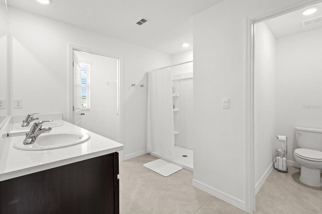 13691 Southwest 69th Terrace Ocala, FL 34473 - Photo 23 of 44 a bathroom with a sink a toilet and shower