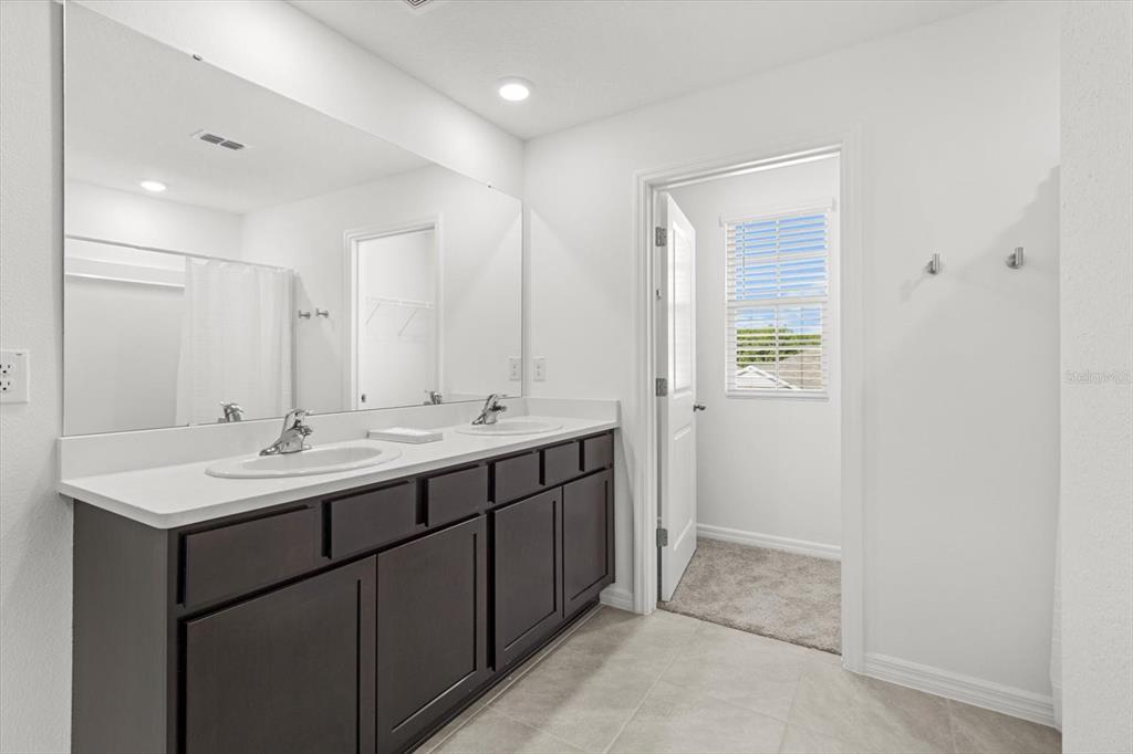 13691 Southwest 69th Terrace Ocala, FL 34473 - Photo 24 of 44 a bathroom with 2 sink and a mirror