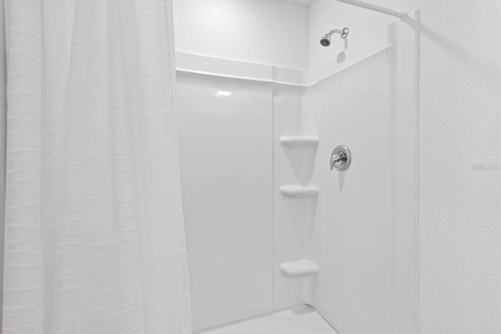 13691 Southwest 69th Terrace Ocala, FL 34473 - Photo 25 of 44 a bathroom with a toilet and a shower