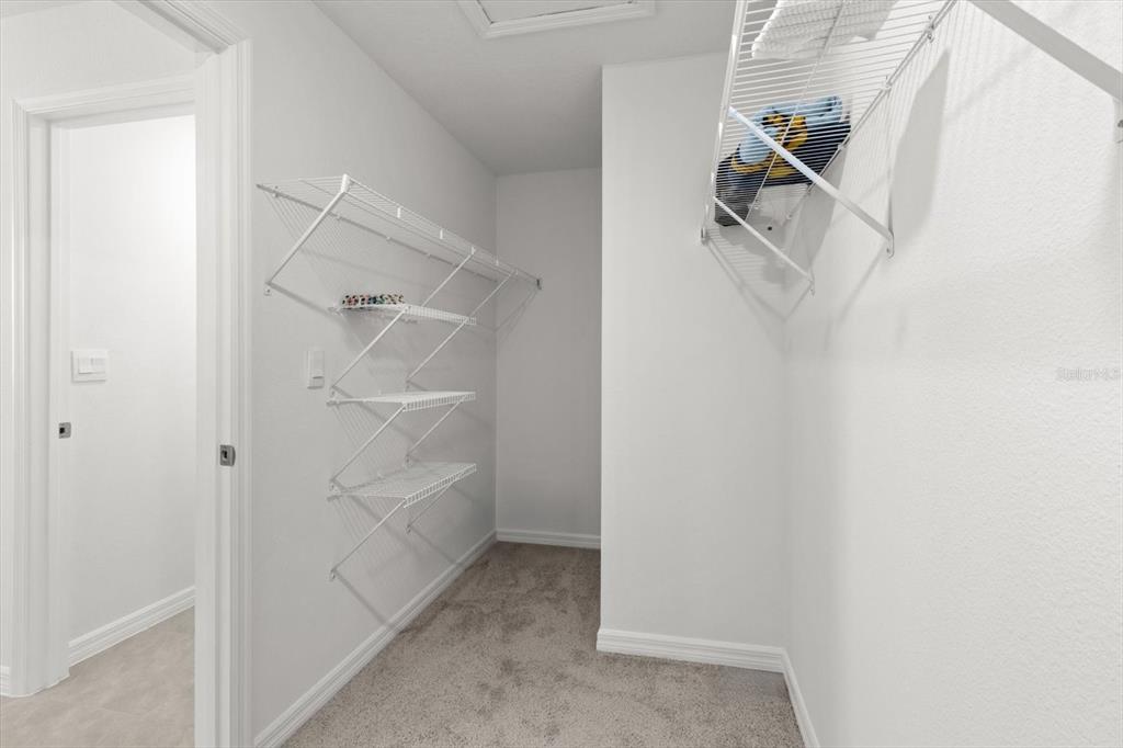 13691 Southwest 69th Terrace Ocala, FL 34473 - Photo 26 of 44 a view of walk in closet with empty racks