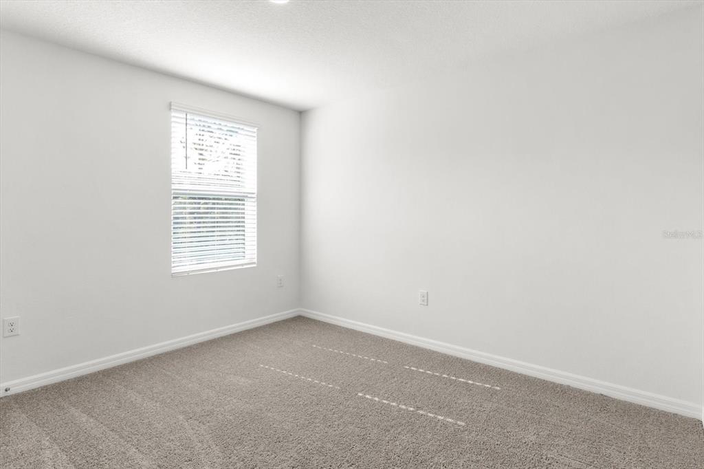 13691 Southwest 69th Terrace Ocala, FL 34473 - Photo 27 of 44 an empty room with a window