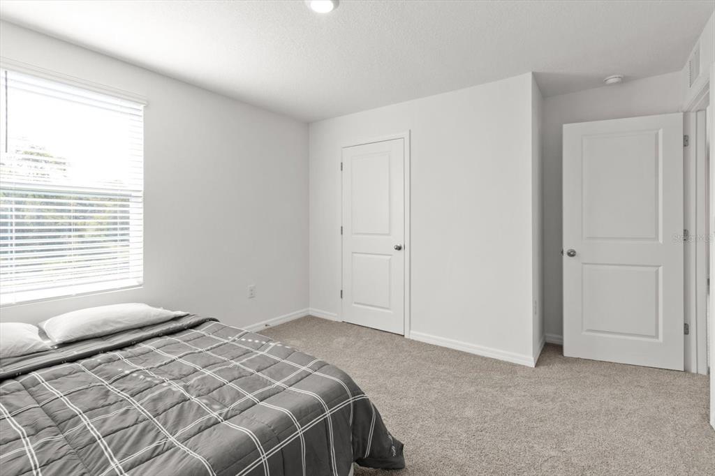 13691 Southwest 69th Terrace Ocala, FL 34473 - Photo 31 of 44 a bedroom with a bed and a window