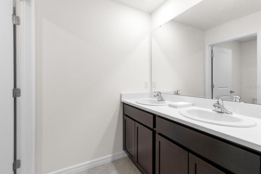 13691 Southwest 69th Terrace Ocala, FL 34473 - Photo 32 of 44 a bathroom with a sink and a mirror