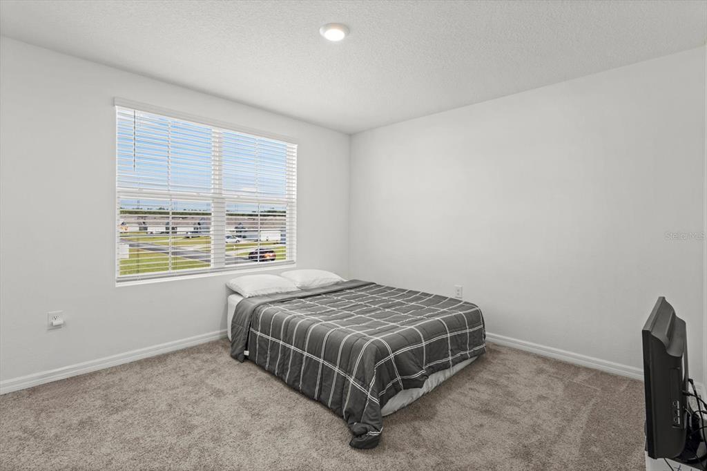 13691 Southwest 69th Terrace Ocala, FL 34473 - Photo 34 of 44 a bedroom with a bed and window