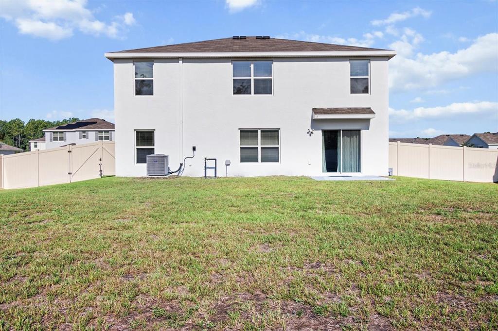 13691 Southwest 69th Terrace Ocala, FL 34473 - Photo 38 of 44 a large white house with a big yard and large trees