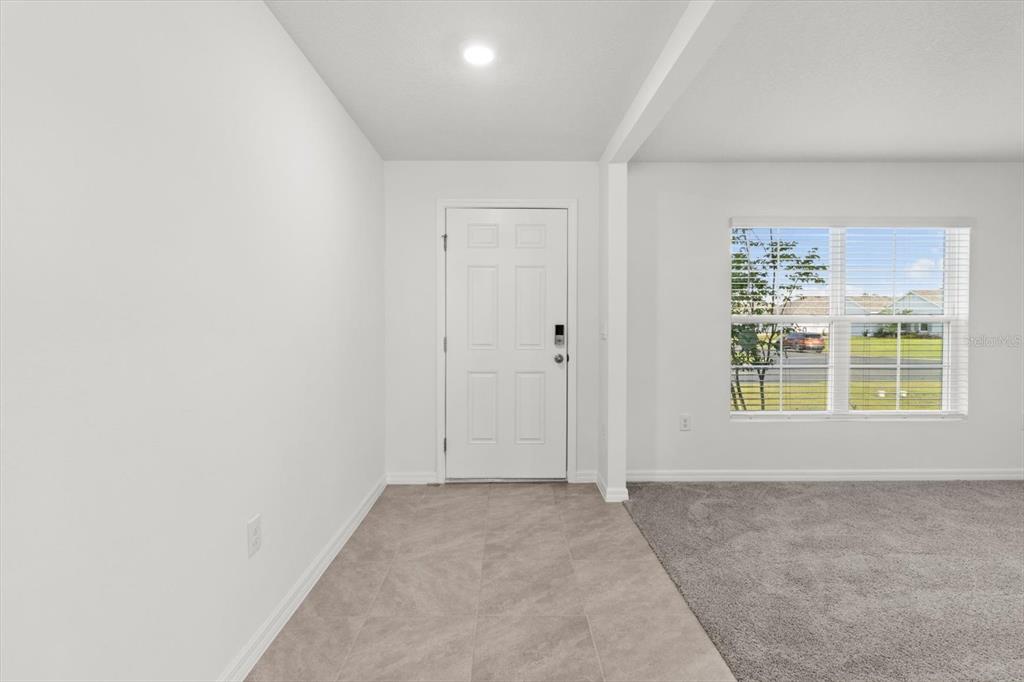 13691 Southwest 69th Terrace Ocala, FL 34473 - Photo 6 of 44 an empty room with a empty space and windows