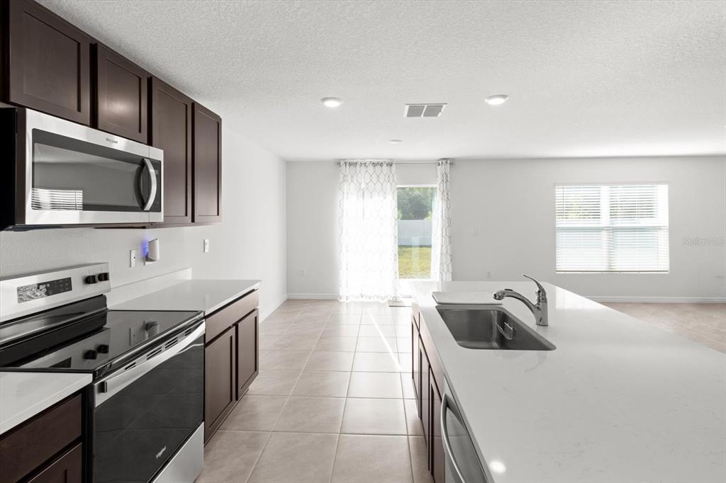 13691 Southwest 69th Terrace Ocala, FL 34473 - Photo 10 of 44 a kitchen that has a sink and a stove