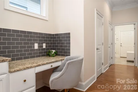 a bathroom with a granite countertop sink a toilet and shower