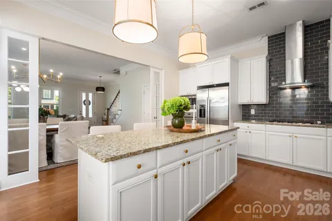 a kitchen with stainless steel appliances granite countertop counter space a sink cabinets and wooden floor