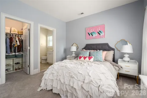 a bedroom with a bed and a lamp