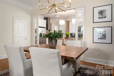 a dining room with furniture and wooden floor
