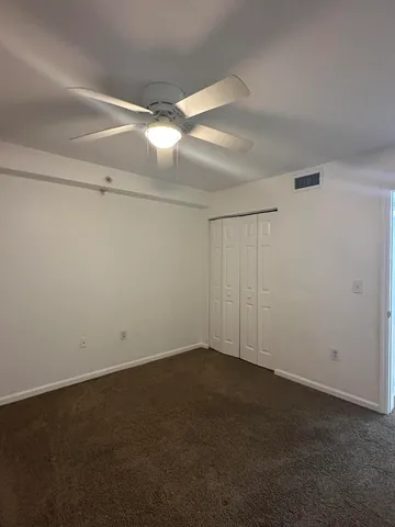 a kitchen with a stove a refrigerator and white cabinets