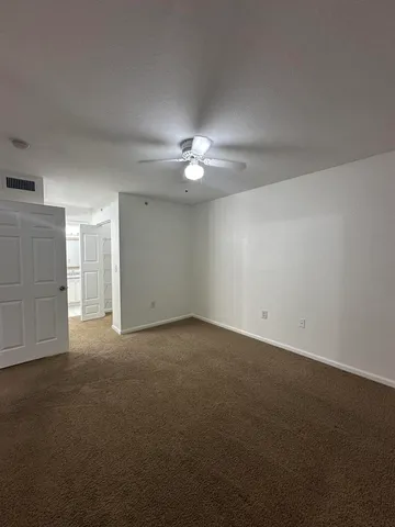 a view of a kitchen with sink and cabinets