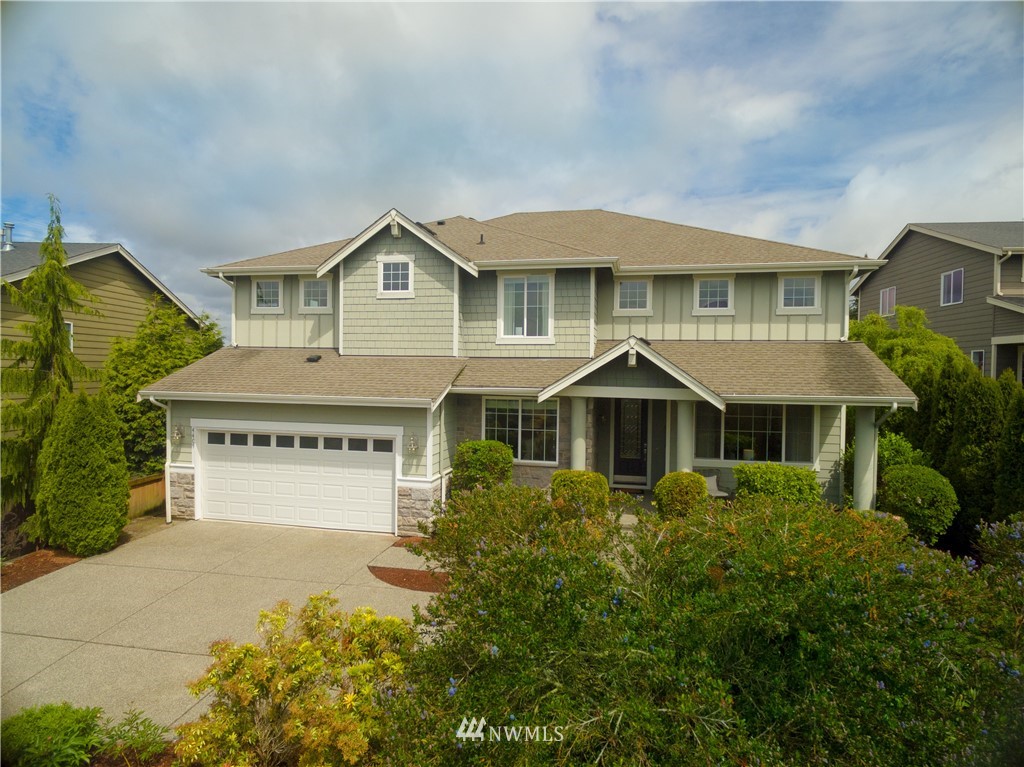 4407 219th Street Southeast Bothell, WA 98021 - Photo 2 of 33 a front view of a house with a yard and garage