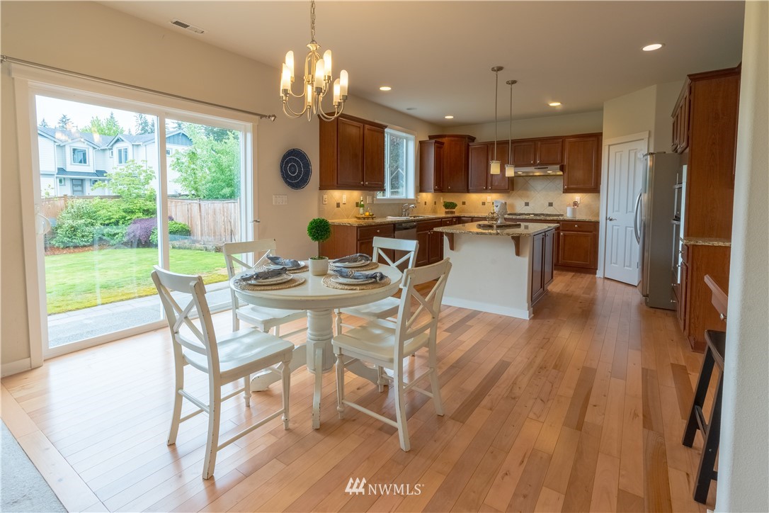 4407 219th Street Southeast Bothell, WA 98021 - Photo 11 of 33 a view of a dining room with furniture window and wooden floor