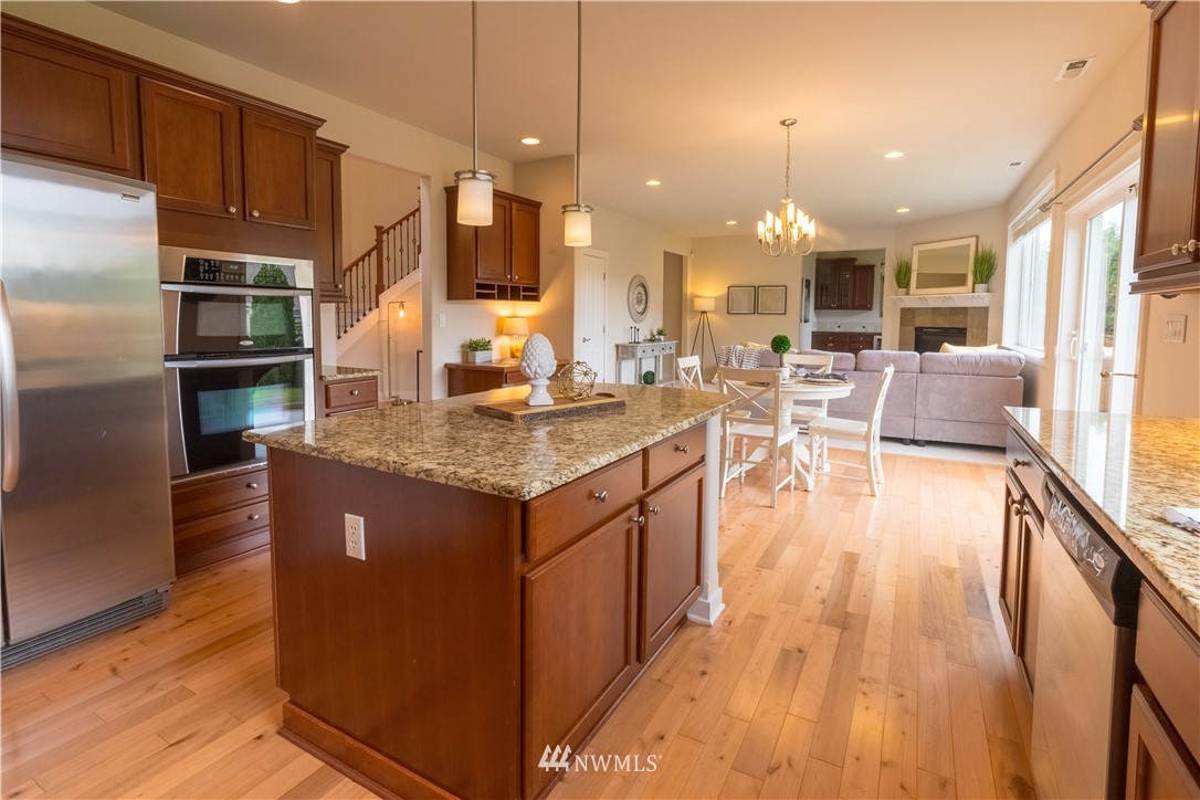 4407 219th Street Southeast Bothell, WA 98021 - Photo 12 of 33 a kitchen with stainless steel appliances granite countertop a sink a stove and a refrigerator