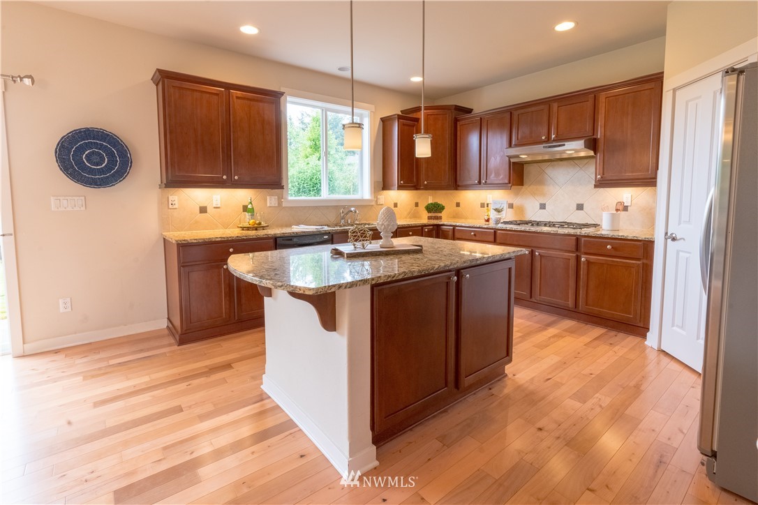 4407 219th Street Southeast Bothell, WA 98021 - Photo 13 of 33 a kitchen with stainless steel appliances granite countertop a stove a sink dishwasher and a refrigerator