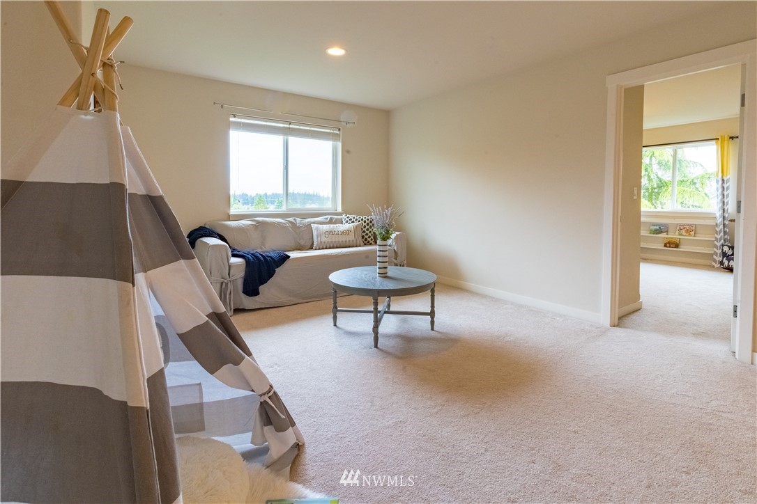 4407 219th Street Southeast Bothell, WA 98021 - Photo 18 of 33 a living room with furniture and a window