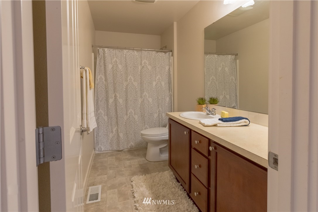 4407 219th Street Southeast Bothell, WA 98021 - Photo 22 of 33 a bathroom with a sink a toilet and shower