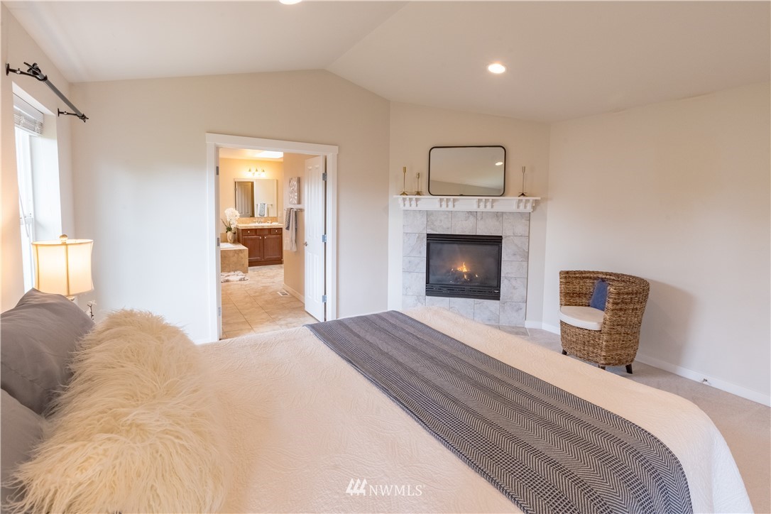 4407 219th Street Southeast Bothell, WA 98021 - Photo 24 of 33 a bedroom with a bed and a fireplace