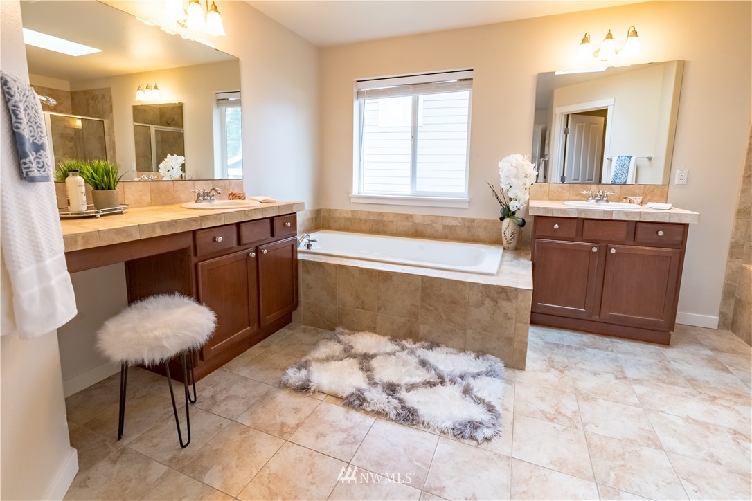 4407 219th Street Southeast Bothell, WA 98021 - Photo 25 of 33 a spacious bathroom with a tub sink and mirror