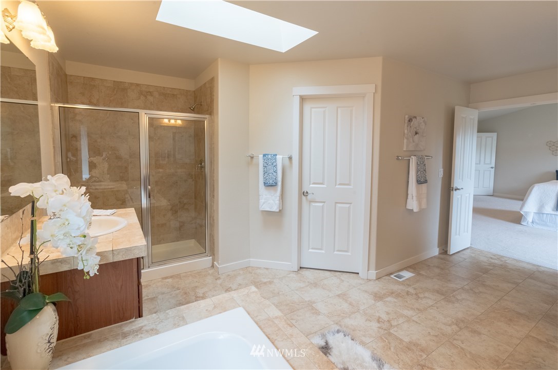 4407 219th Street Southeast Bothell, WA 98021 - Photo 26 of 33 a view of a room with wooden floor and bathroom
