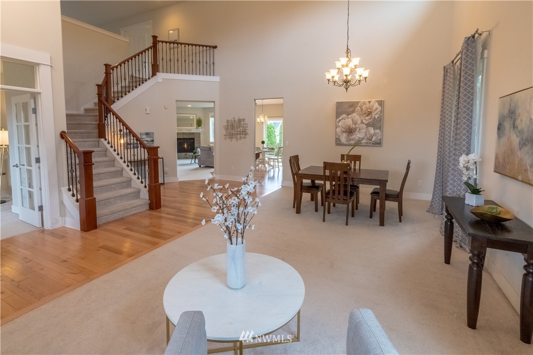 4407 219th Street Southeast Bothell, WA 98021 - Photo 4 of 33 a dining room with furniture a chandelier and wooden floor