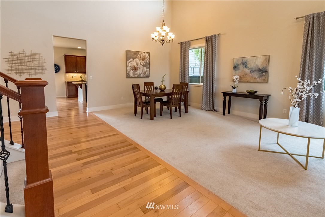 4407 219th Street Southeast Bothell, WA 98021 - Photo 8 of 33 a living room with furniture a fireplace and a chandelier