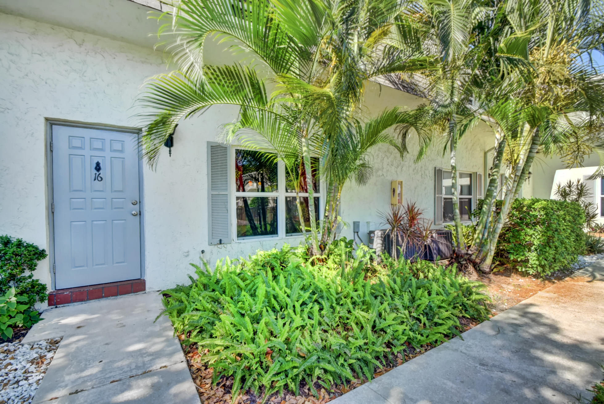 1845 Northwest 4th Avenue, Unit 16 Boca Raton, FL 33432 - Photo 1 of 37 front view of a house with a small yard