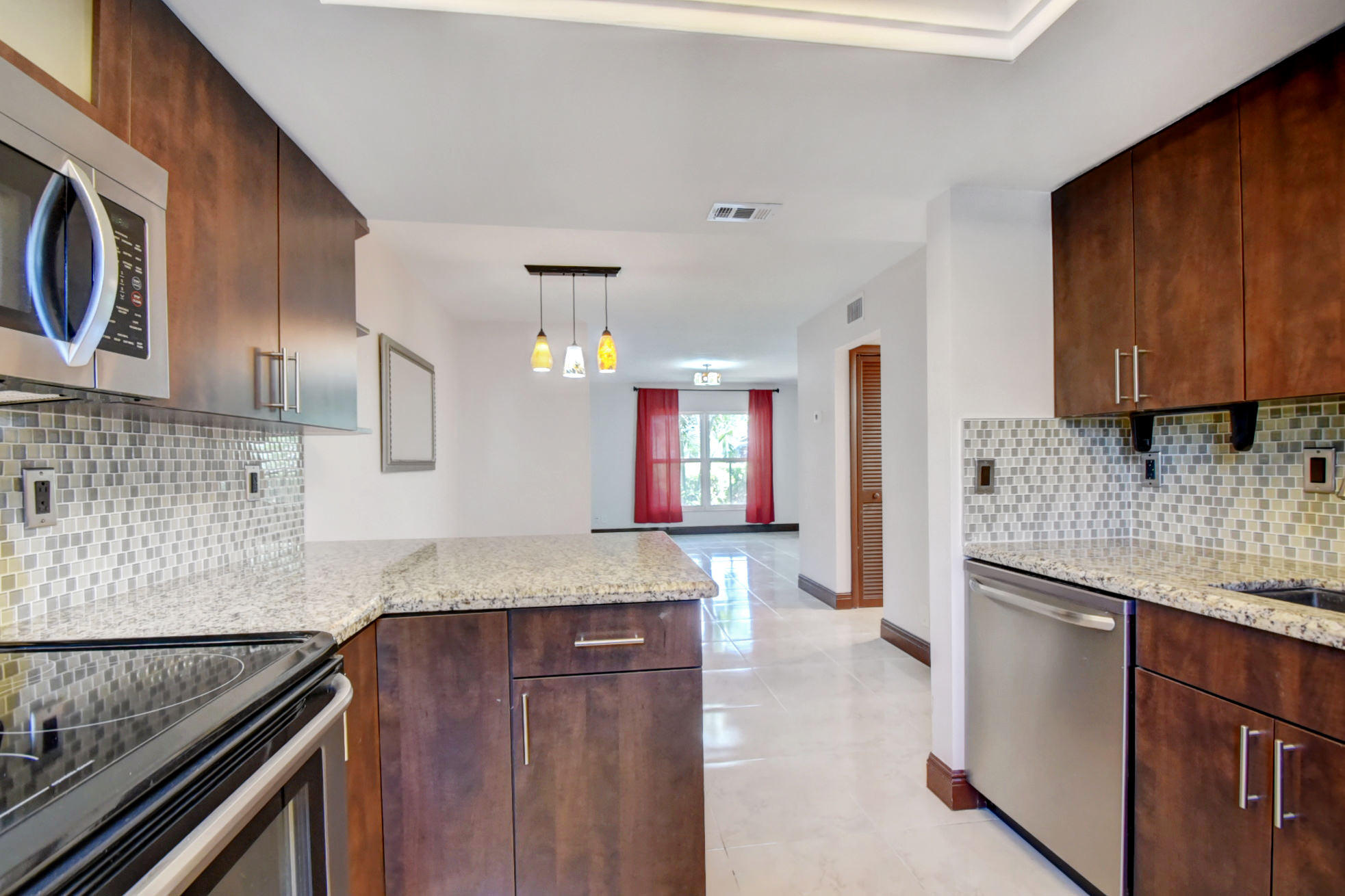 1845 Northwest 4th Avenue, Unit 16 Boca Raton, FL 33432 - Photo 13 of 37 a kitchen with granite countertop cabinets stainless steel appliances and a counter space
