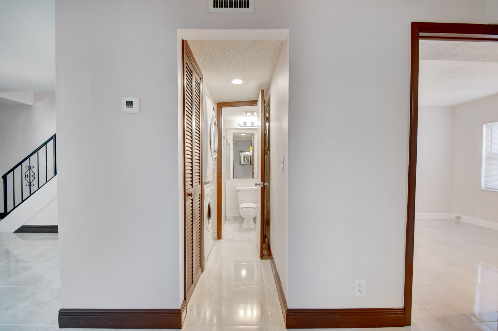 1845 Northwest 4th Avenue, Unit 16 Boca Raton, FL 33432 - Photo 16 of 37 a view of a hallway with wooden floor