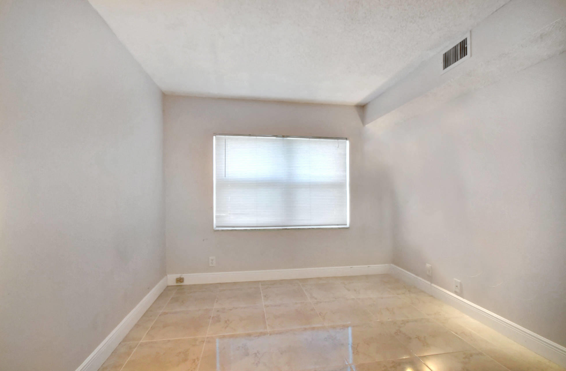 1845 Northwest 4th Avenue, Unit 16 Boca Raton, FL 33432 - Photo 17 of 37 an empty room with a window