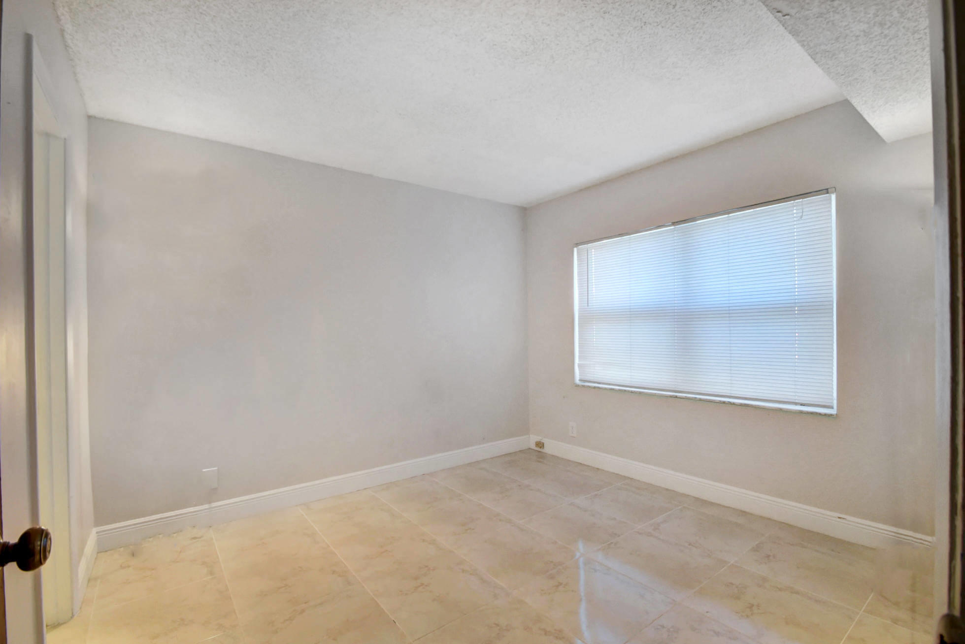 1845 Northwest 4th Avenue, Unit 16 Boca Raton, FL 33432 - Photo 20 of 37 an empty room with a window