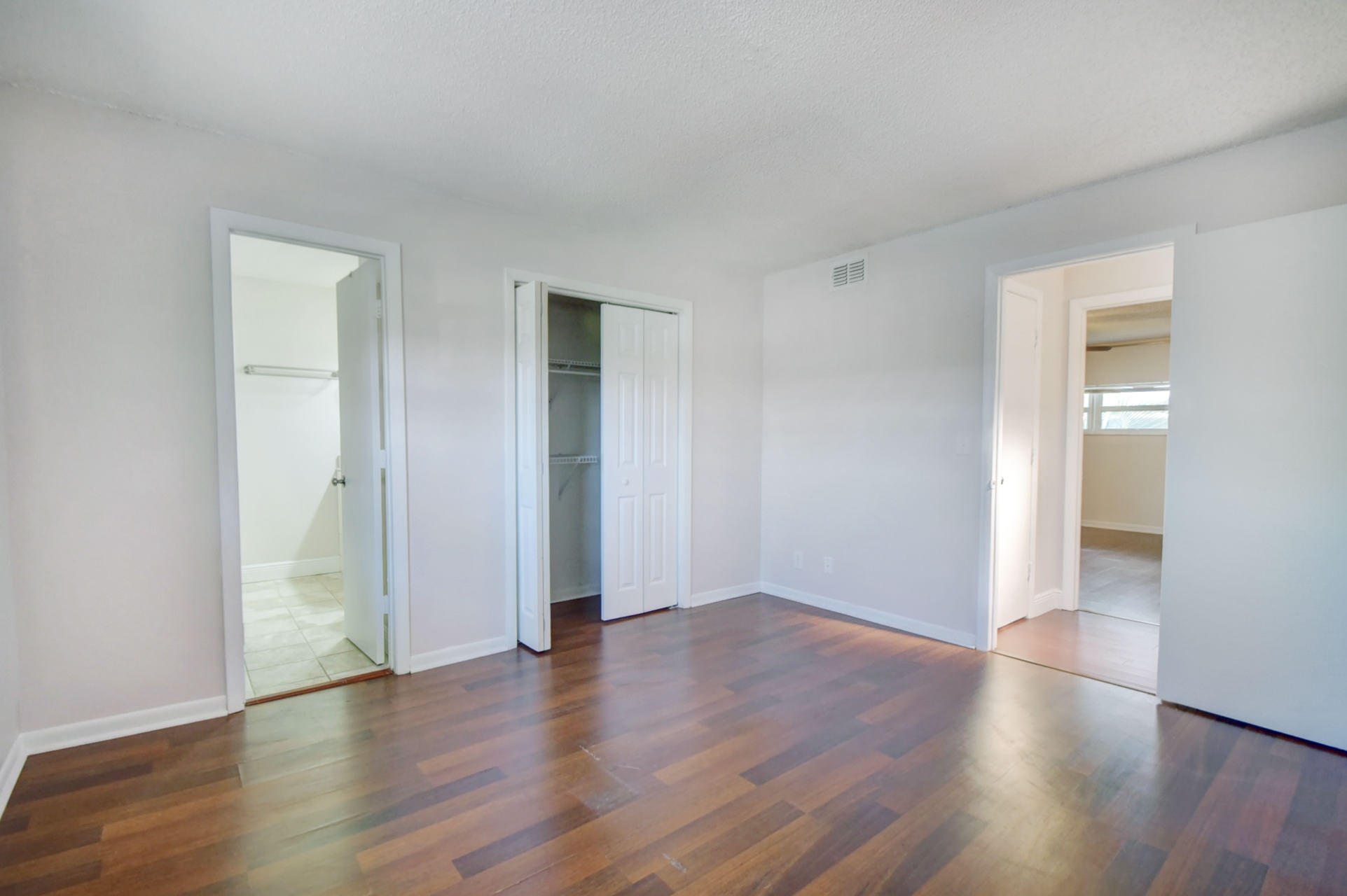 1845 Northwest 4th Avenue, Unit 16 Boca Raton, FL 33432 - Photo 25 of 37 a view of an empty room with wooden floor