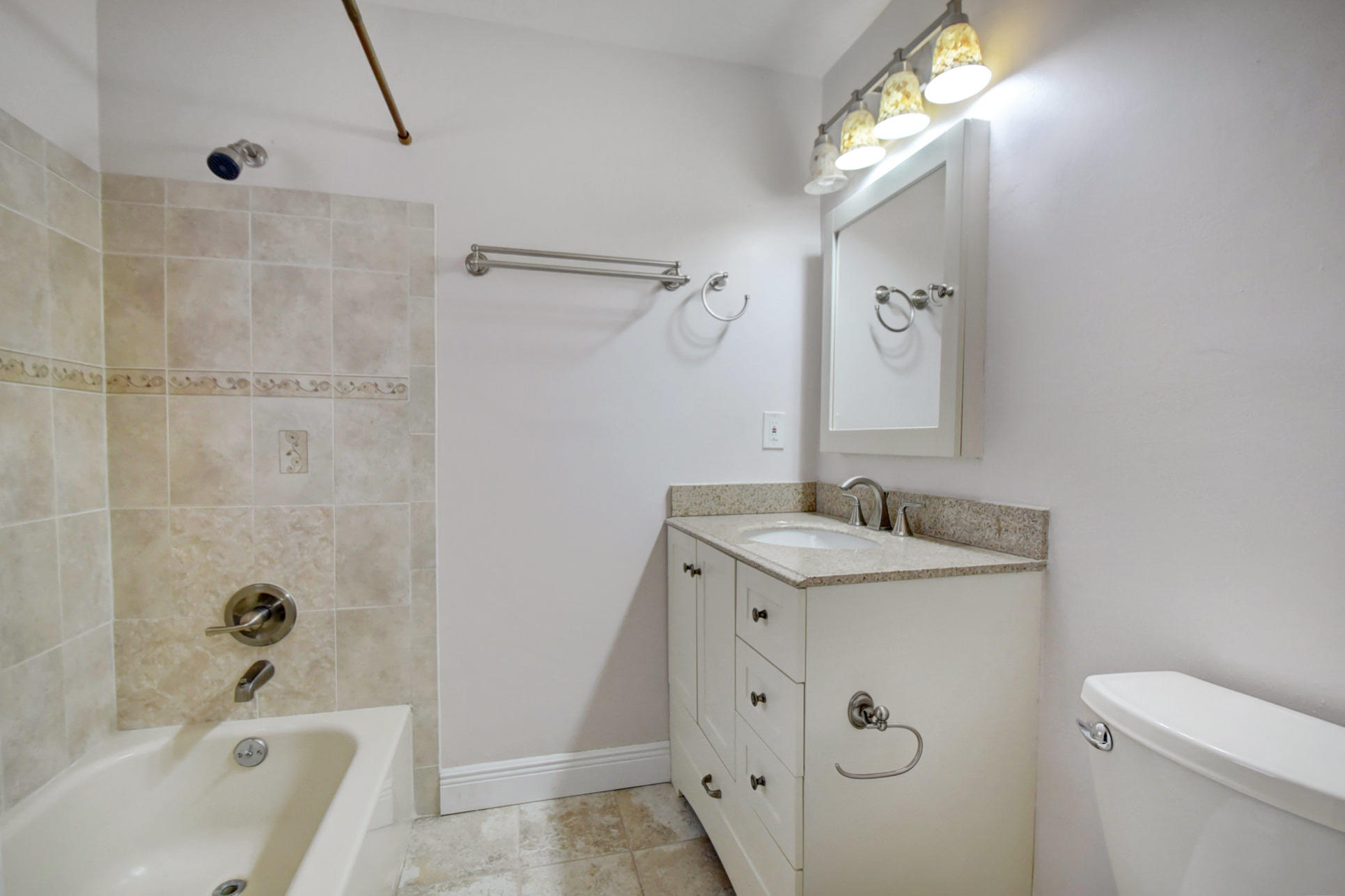 1845 Northwest 4th Avenue, Unit 16 Boca Raton, FL 33432 - Photo 26 of 37 a bathroom with a sink a toilet and shower