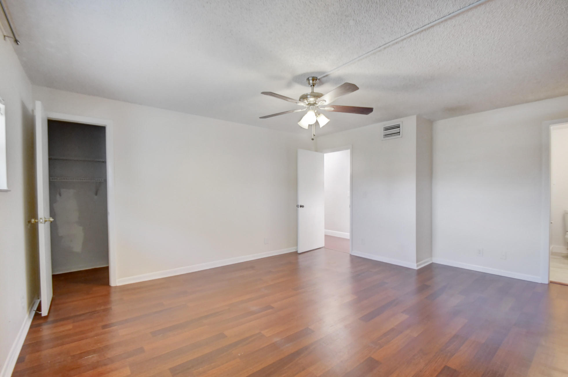 1845 Northwest 4th Avenue, Unit 16 Boca Raton, FL 33432 - Photo 29 of 37 an empty room with wooden floor and window