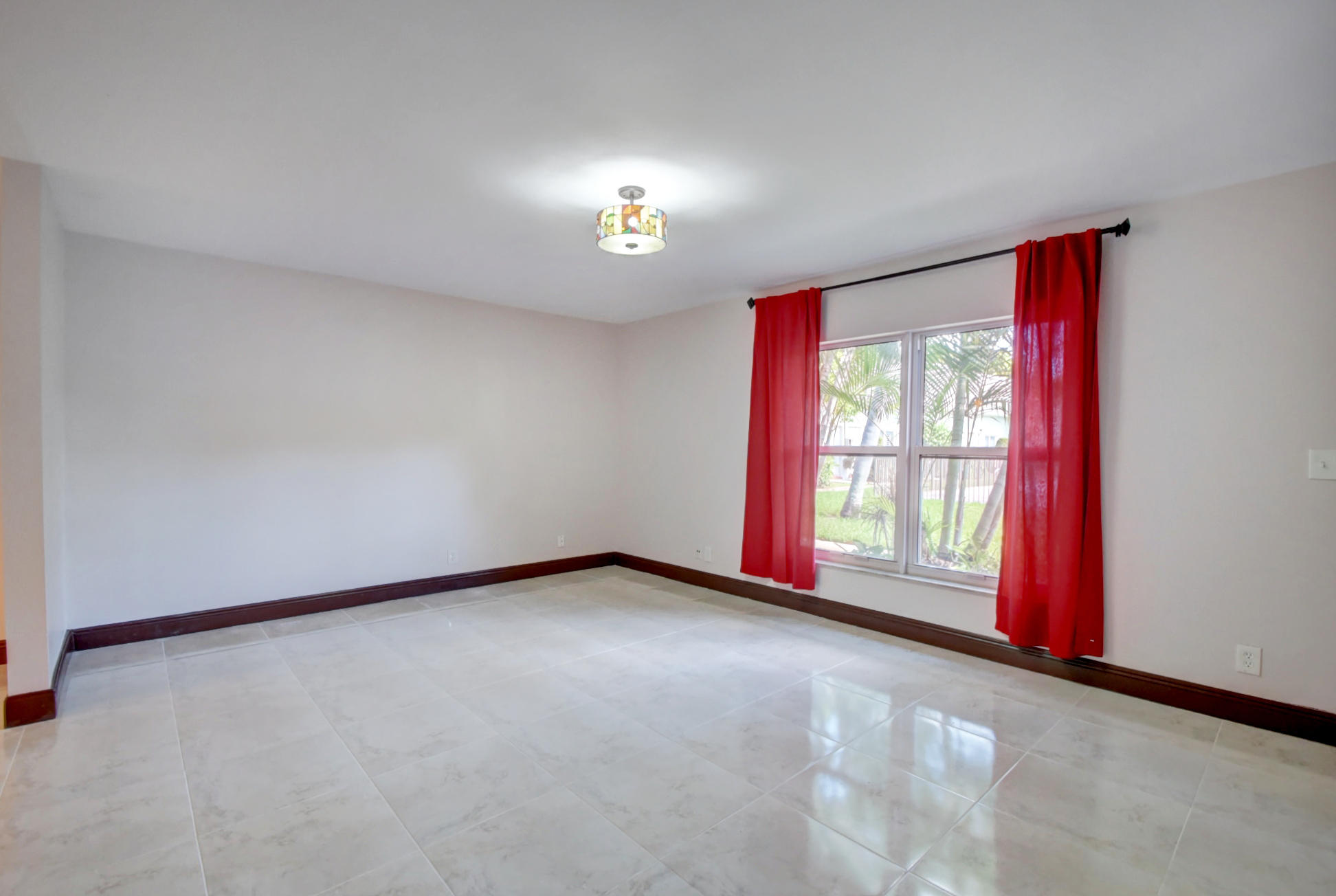 1845 Northwest 4th Avenue, Unit 16 Boca Raton, FL 33432 - Photo 3 of 37 a view of an empty room with a window