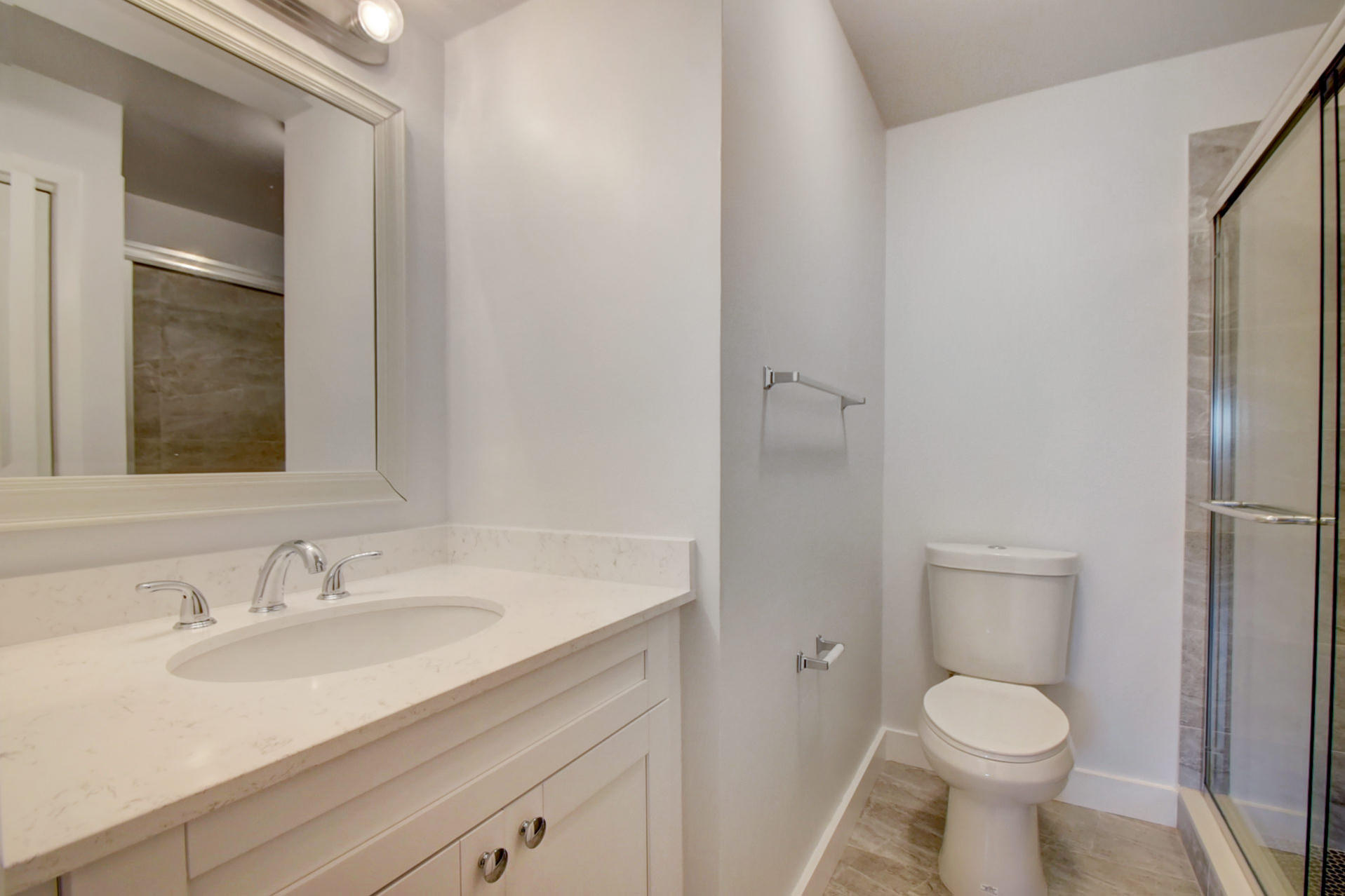 1845 Northwest 4th Avenue, Unit 16 Boca Raton, FL 33432 - Photo 31 of 37 a bathroom with a granite countertop toilet sink and mirror