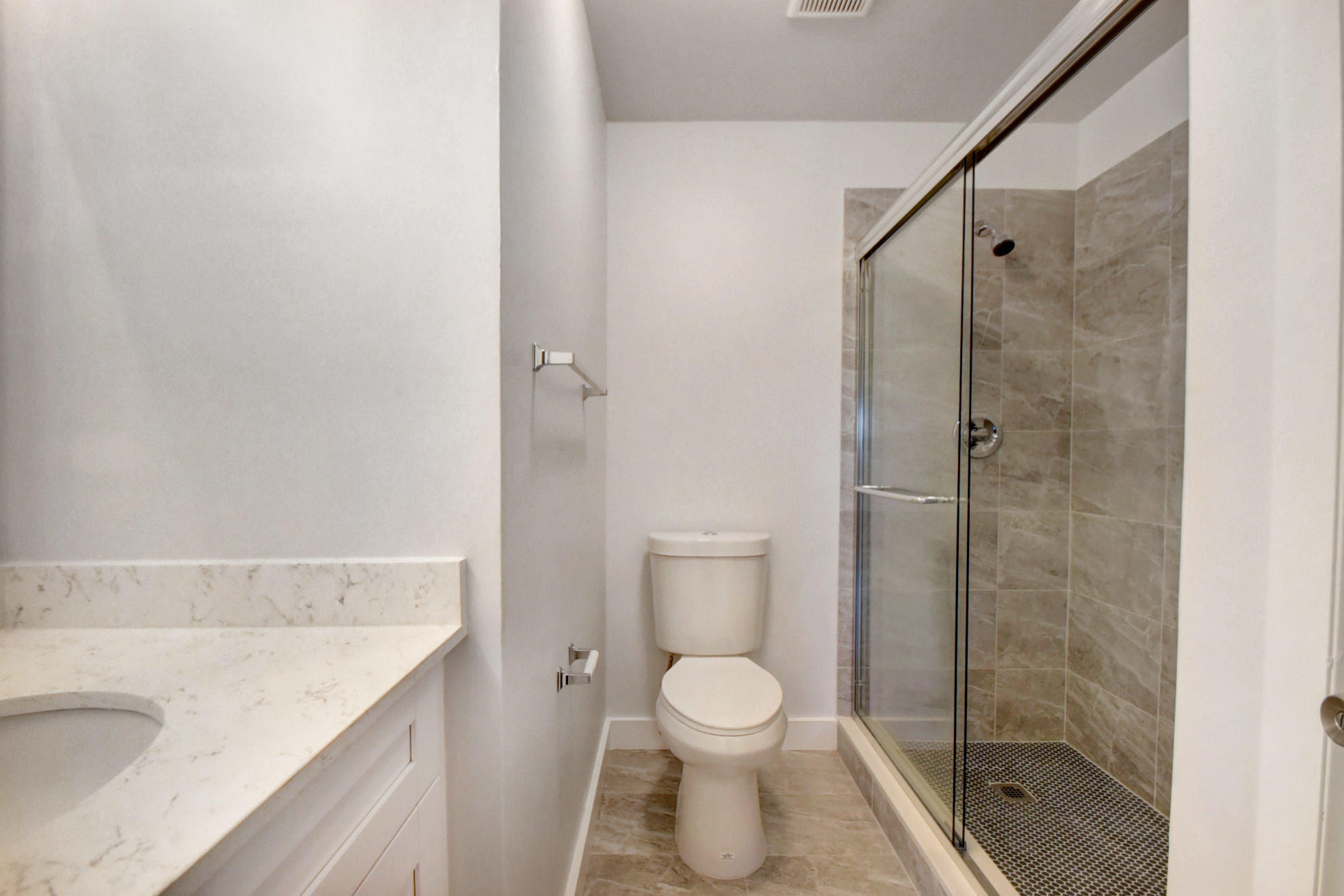 1845 Northwest 4th Avenue, Unit 16 Boca Raton, FL 33432 - Photo 32 of 37 a bathroom with a granite countertop shower a toilet and a sink